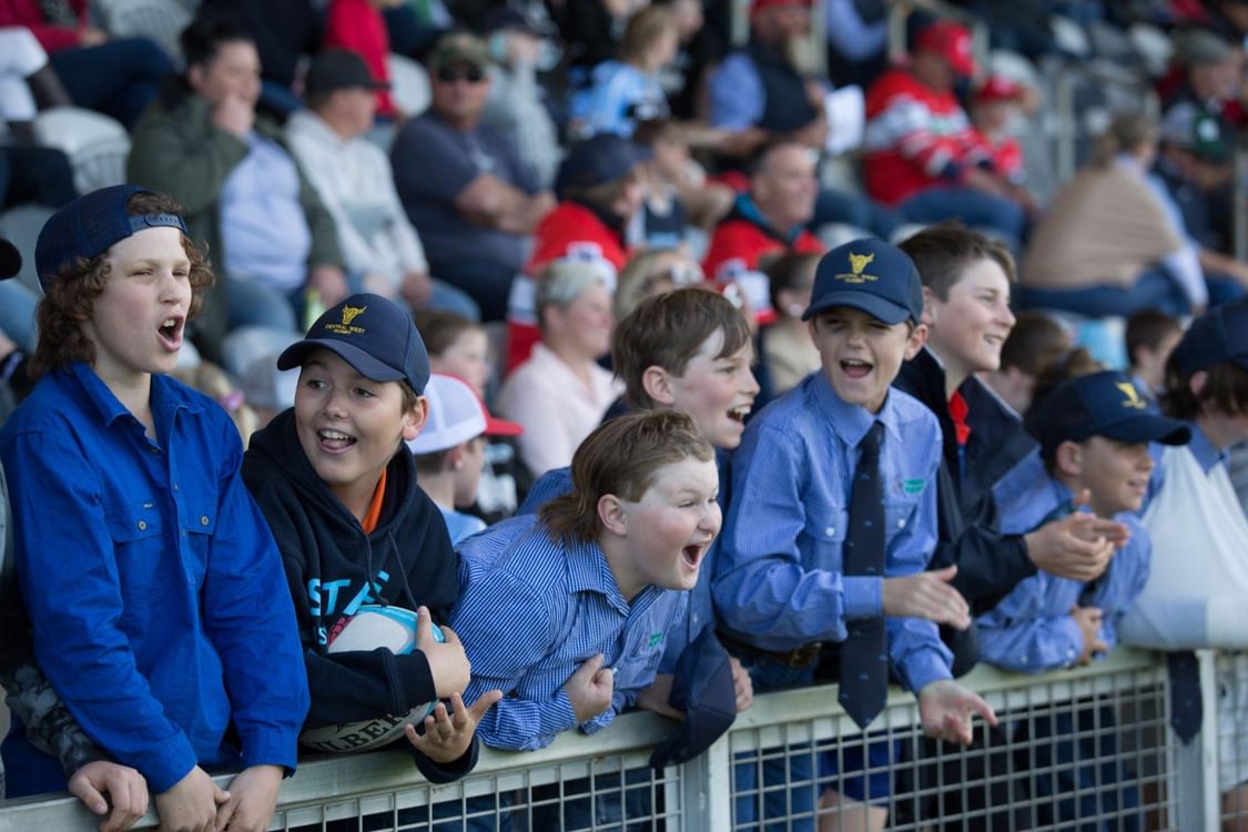 Kids cheering at a sporting match